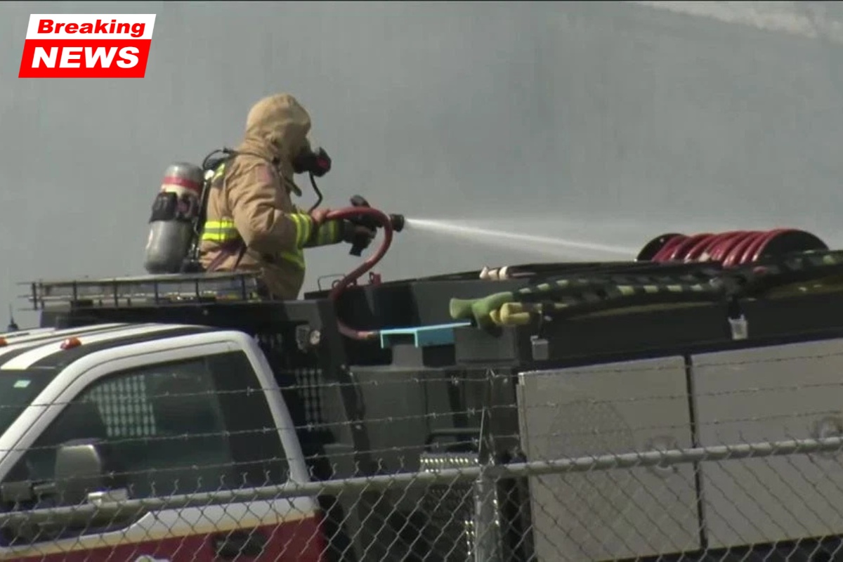 Authorities say a wind-driven wildfire has spread into an auto body shop in Oklahoma City