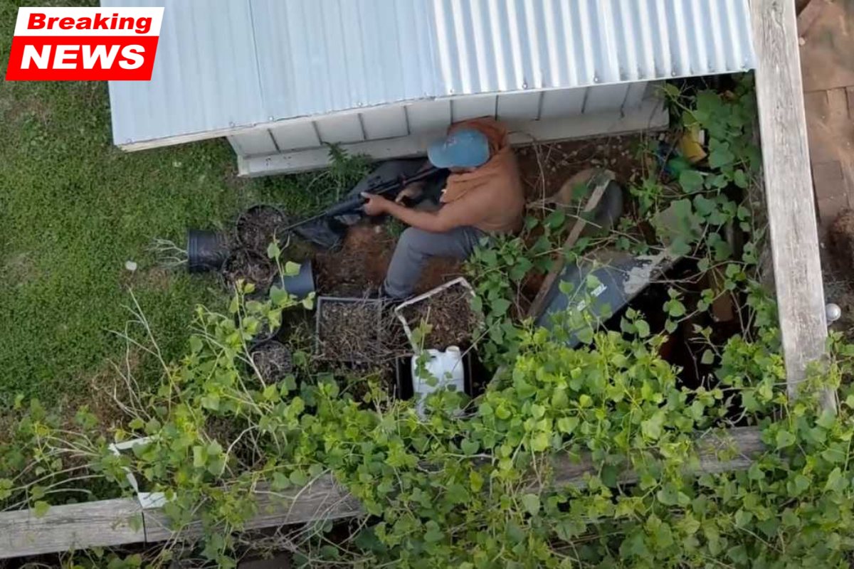 An armed man is seen on video from drones hiding behind a neighbor's shed during an hours-long standoff